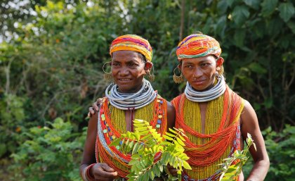 Indigenous villagers in the heavily forested state of Odisha, India, with the forest behind them 